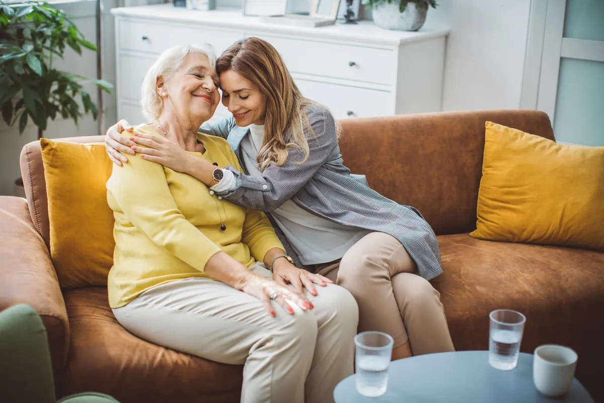 Adult daughter comforting her aging mother, highlighting emotional moments of caregiving