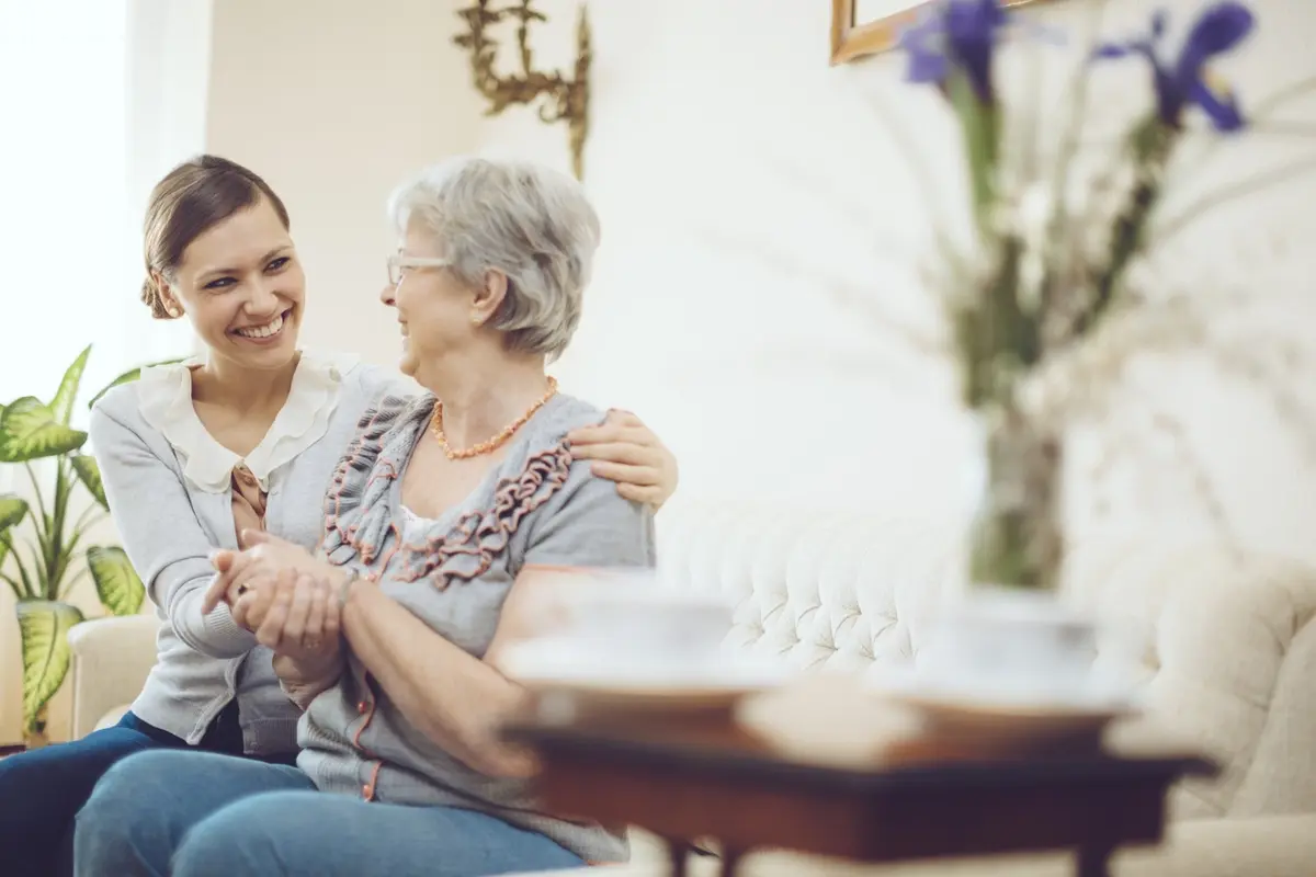 What makes assisted care in Gresham unique, a caregiver visits a resident at Farmington Square Gresham